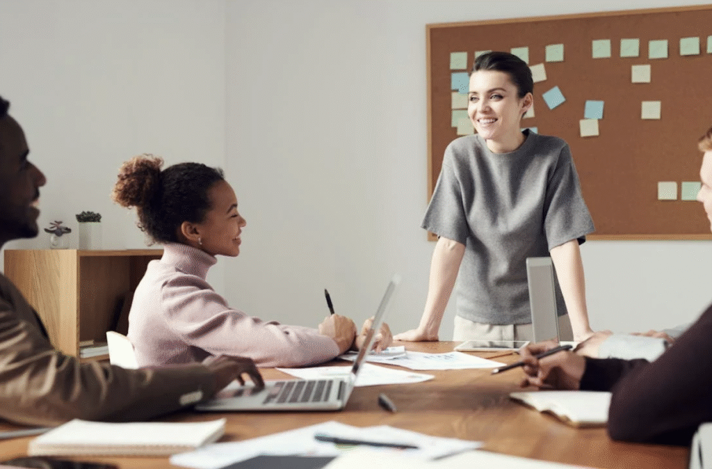 Woman Wearing Gray Shirt Leading a Meeting